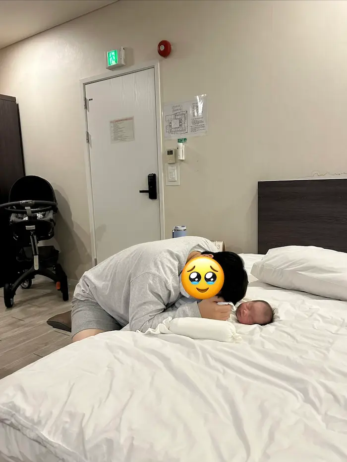 Father bonding with his newborn baby during rooming-in at a Korean Postpartum Care Center