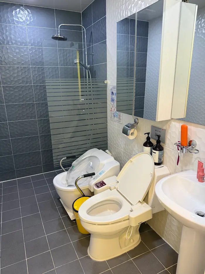 Private bathroom with sitz bath equipment inside a Korean Postpartum Care Center