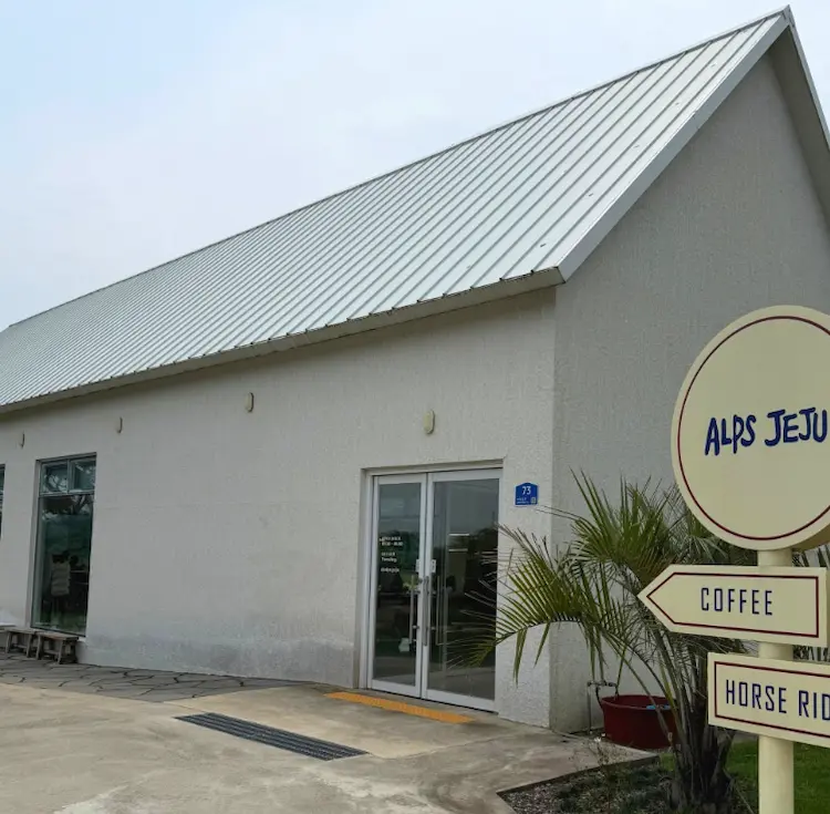 Exterior of Alps Jeju Cafe with its signature white building in Jeju