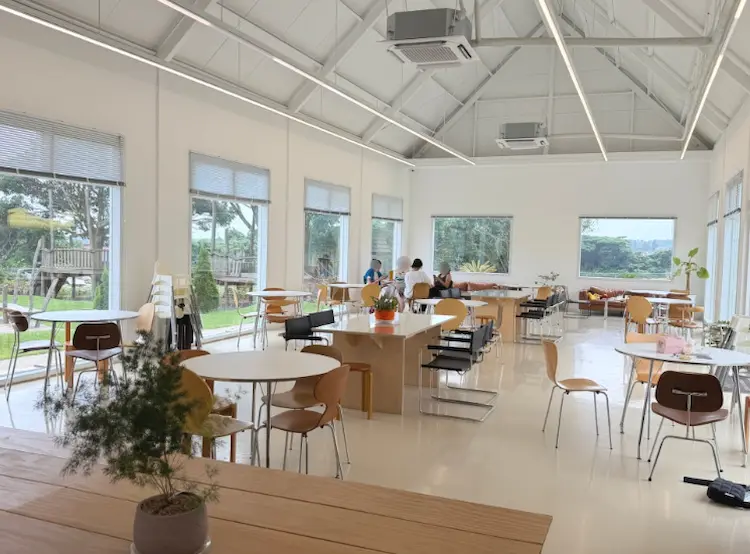 Minimalist cafe interior at Alps Jeju with large windows
