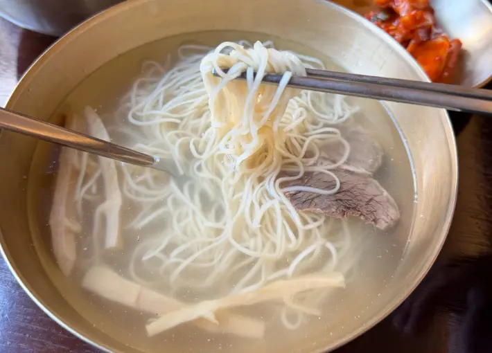 Clear broth noodles with beef slices at Myeon Seoul
