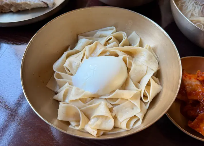 Flat handmade noodles before mixing at Myeon Seoul