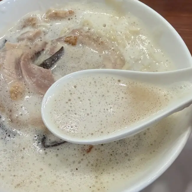 Close-up of the creamy chicken broth at OreNo Ramen