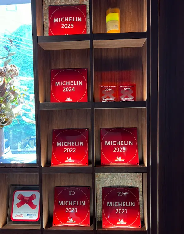 Michelin Guide plaques displayed inside Osteria Orzo in Seoul
